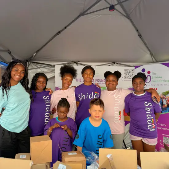 Volunteers packing backpacks with school supplies for local students.
